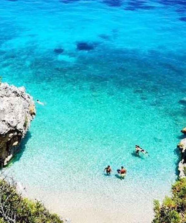 Beautiful tropical beach with turquoise waters and rocky cliffs. Perfect for relaxing holidays and w.