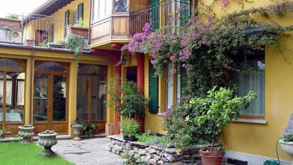 Colourful villa with lush greenery and blooming flowers, perfect for a relaxing holiday stay.