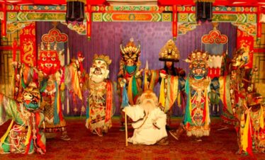 Traditional Asian puppet show with colourful costumes and masks.