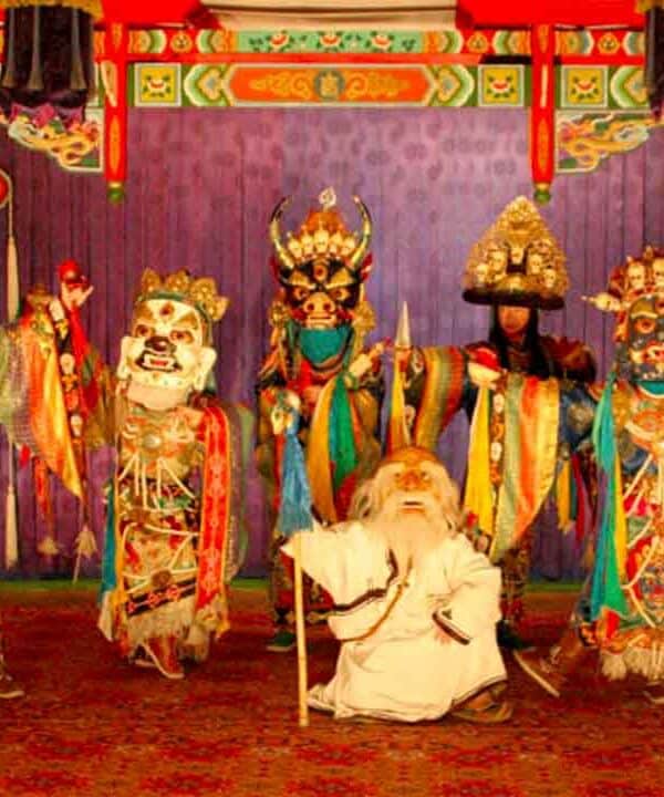 Traditional Asian puppet show with colourful costumes and masks.