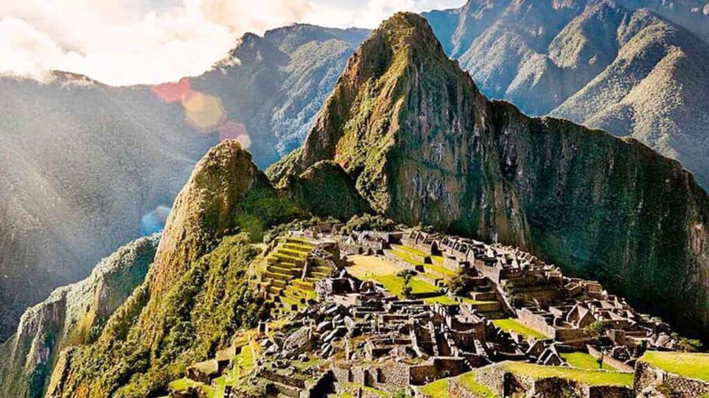 Ancient Incan city of Machu Picchu nestled high in the Andes, surrounded by lush green mountains and.