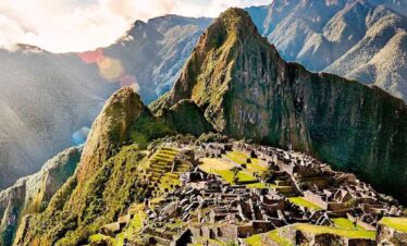 Ancient Incan city of Machu Picchu nestled high in the Andes, surrounded by lush green mountains and.