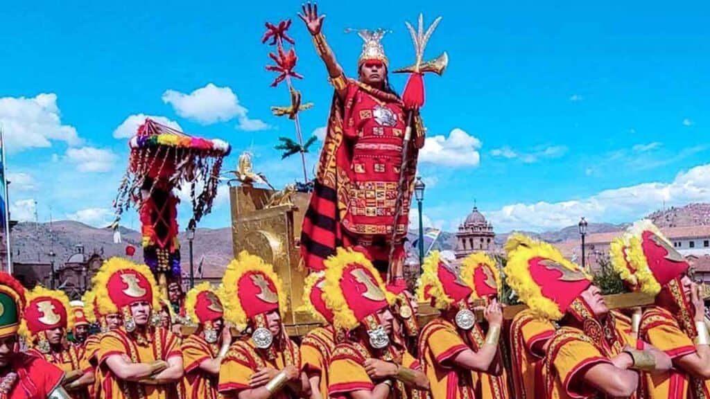 Vibrant festival parade featuring traditional costumes and a regal figure on a decorated float.