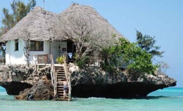 Charming beach hut on a rocky outcrop with ocean views.