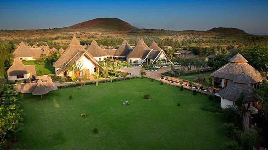 Picturesque eco-resort with traditional thatched-roof cottages and stunning mountain views.