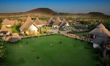 Picturesque eco-resort with traditional thatched-roof cottages and stunning mountain views.