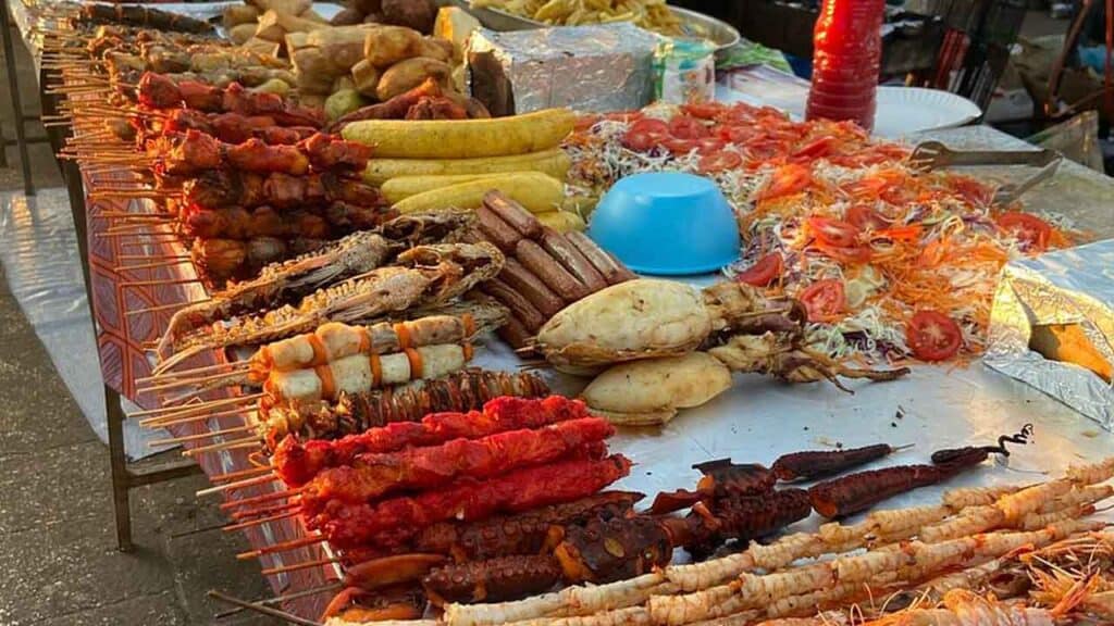 Fresh seafood and skewers at a vibrant market stall.