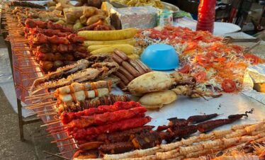 Fresh seafood and skewers at a vibrant market stall.