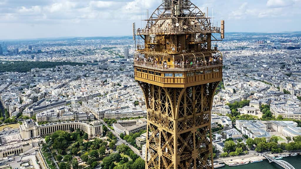 Aerial view of the Eiffel Tower in Paris with cityscape background.